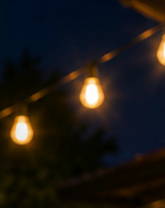 String-light bulbs glowing against a night sky